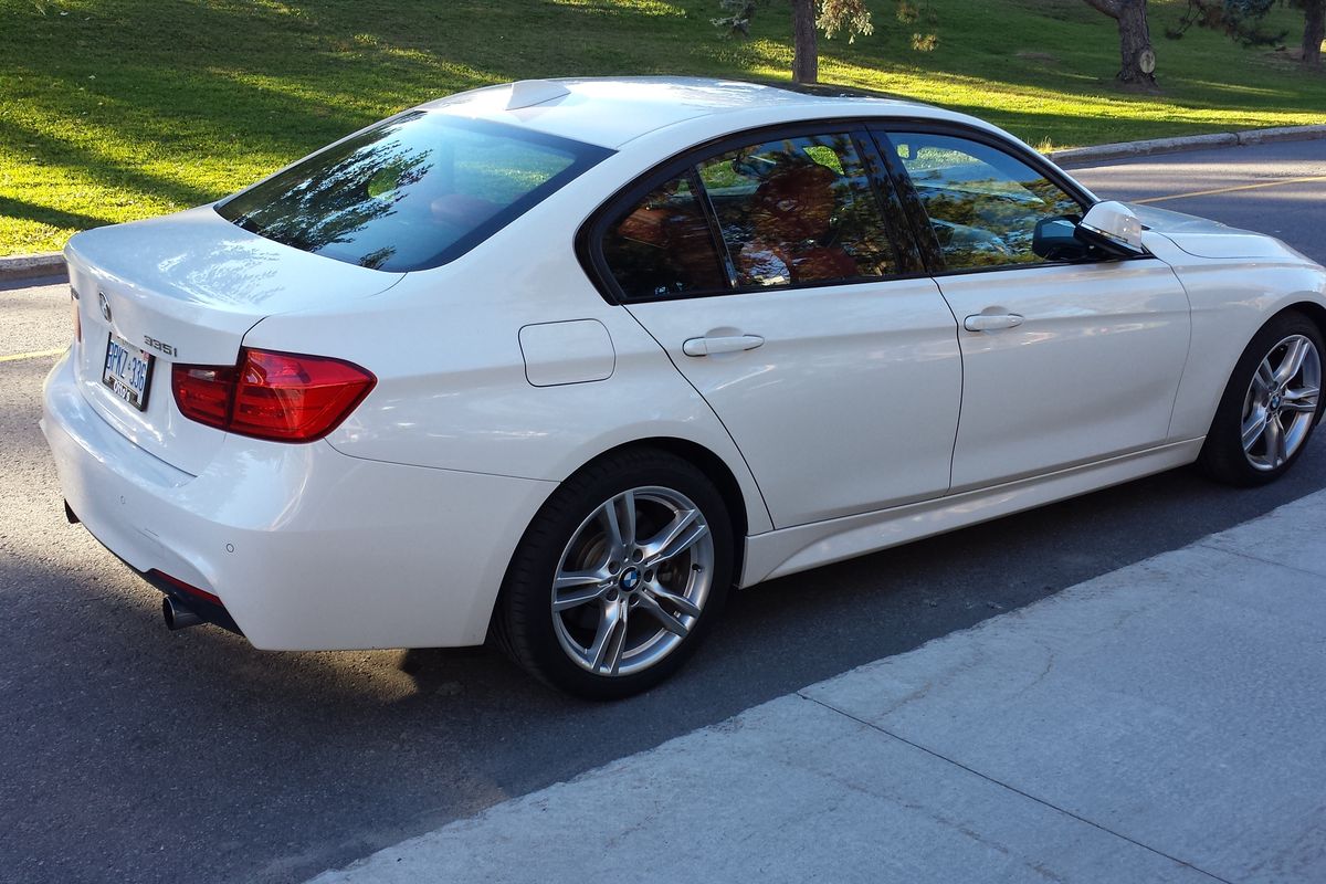 White BMW F30 335i xDrive sedan shown in side profile, showcasing wheel and stance options