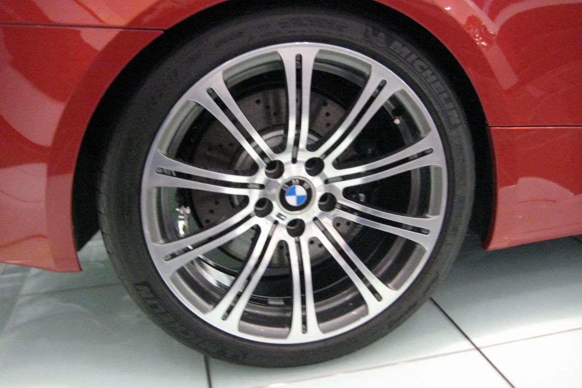 Close-up view of BMW E92 alloy wheel, Michelin tire sidewall and fender arch detail