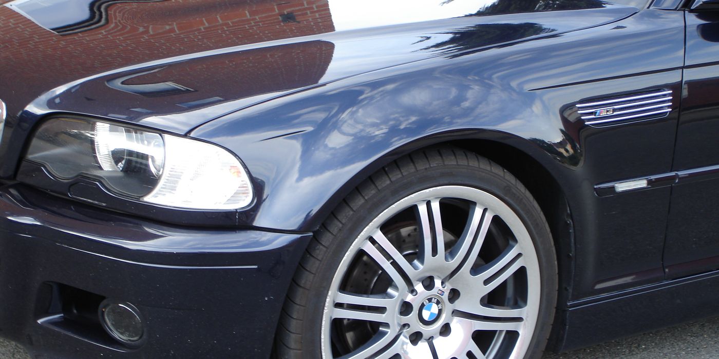 Close-up of BMW E46 M3 Style 67 alloy wheel mounted to car showing spoke pattern and brake caliper