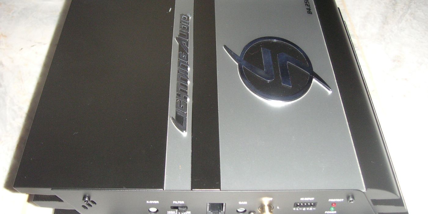 Car audio power amplifier mounted and wired, ready to drive aftermarket speakers