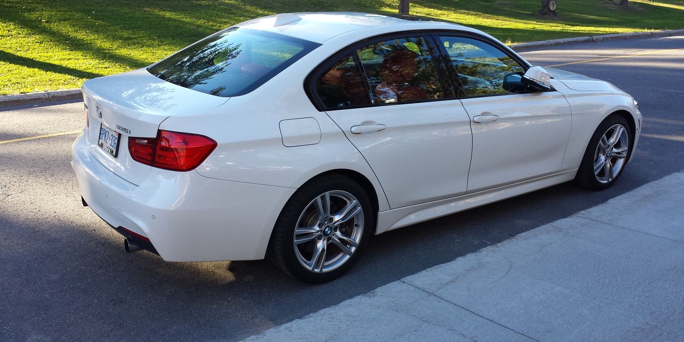 White BMW F30 335i xDrive sedan three-quarter front view with M Sport wheels