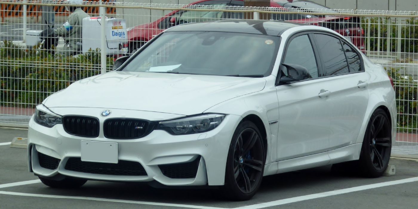 BMW F80 M3 three-quarter view showing factory wheels sitting inside the fender arches with visible gap
