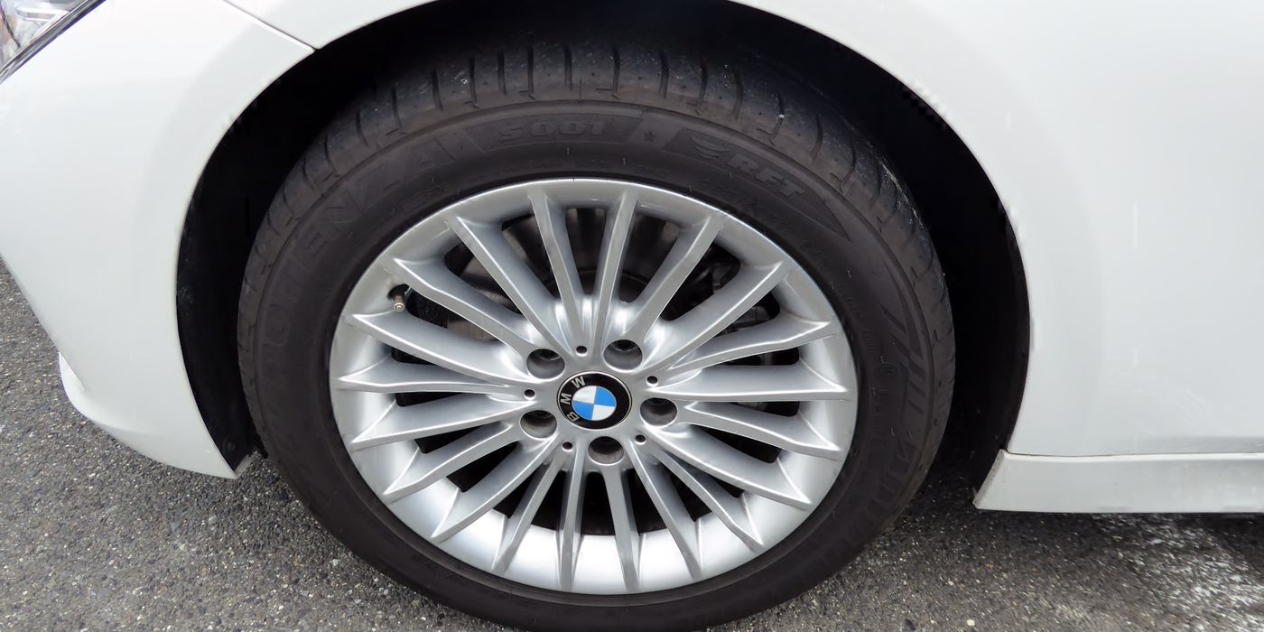 BMW F30 alloy wheel mounted on the hub face showing lug bolts and the hub register