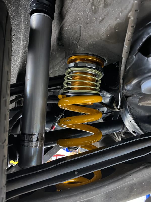 Aftermarket coilover fitted to BMW chassis showing perch and damper