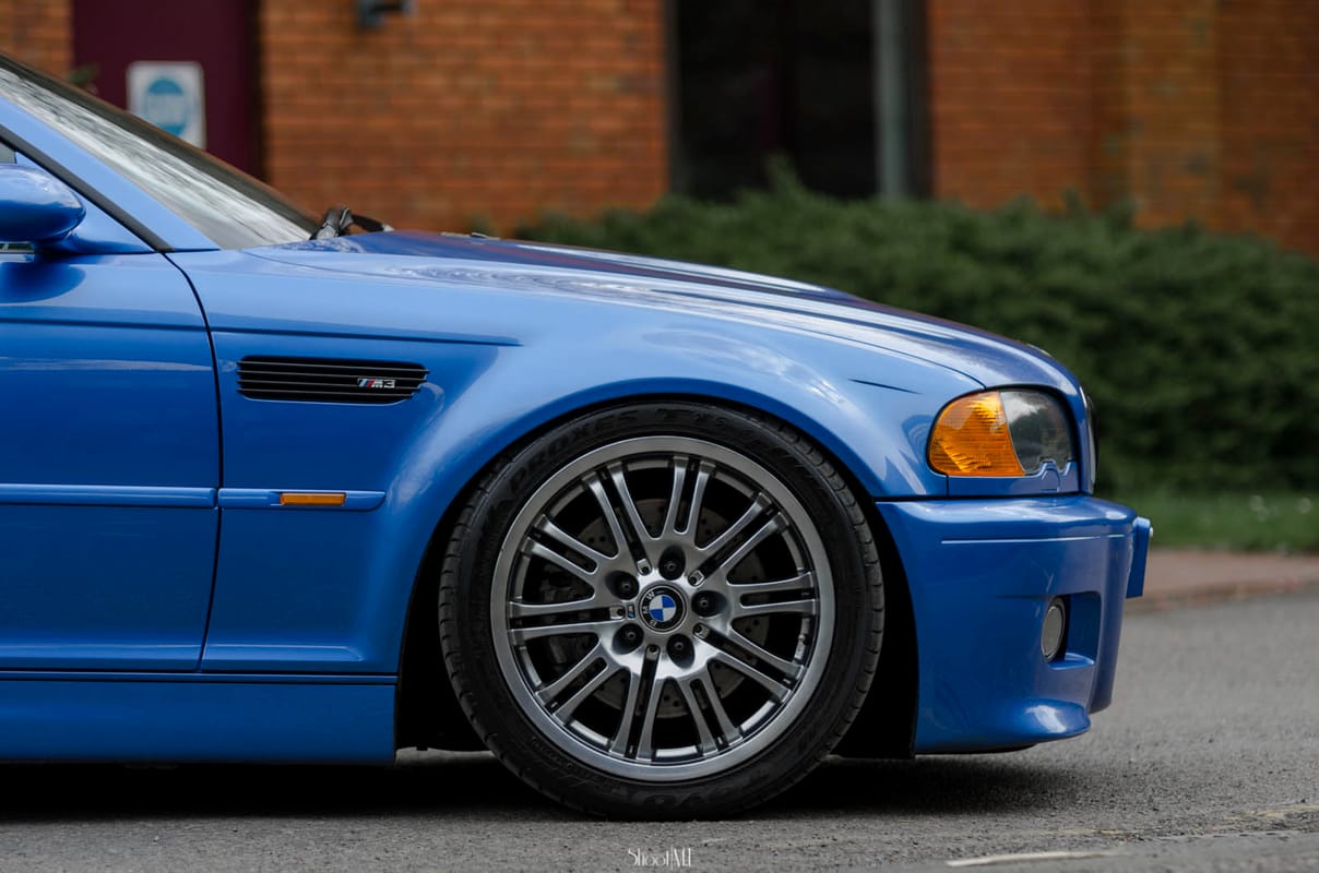 BMW with aftermarket coilovers installed showing reduced fender gap