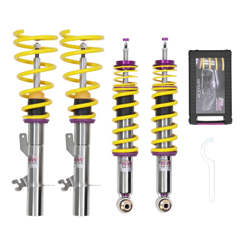 Aftermarket coilover assembly on a workbench showing spring perch, damper body, and top mount