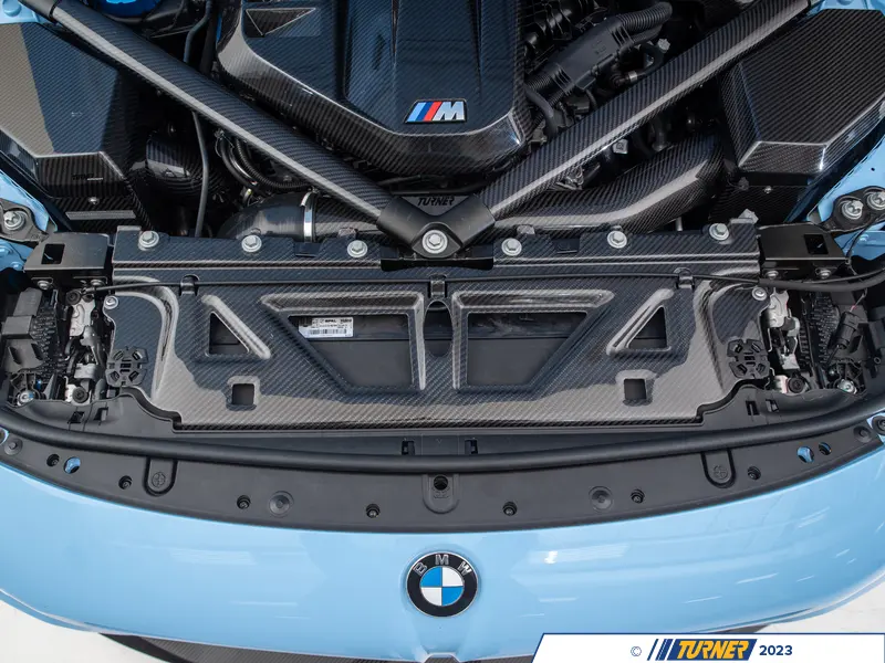 Turner carbon radiator cover detail view showing pre-preg carbon fiber weave pattern and gloss UV-resistant clear coat on G8X application