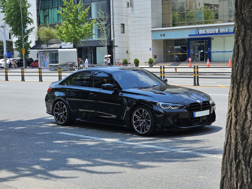 BMW M3 Competition G80 sedan in Black Sapphire Metallic, front three-quarter view of the current-generation flagship M3